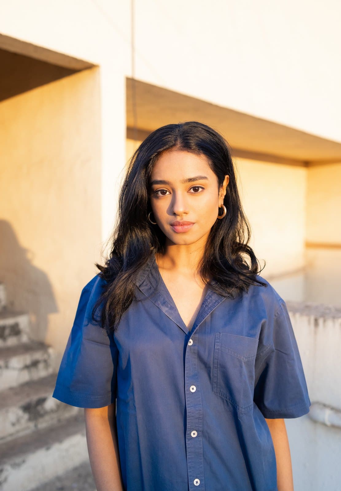 Malavika in a soft blue shirt — direct portrait